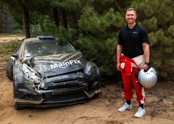 Speedcafe journalist Simon Chapman with the remains of the White Wolf Racing Ford Fiesta R5. Image: Jack Martin