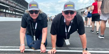 Wendy and Brent L'Amie kiss the row of bricks at the Indy 500